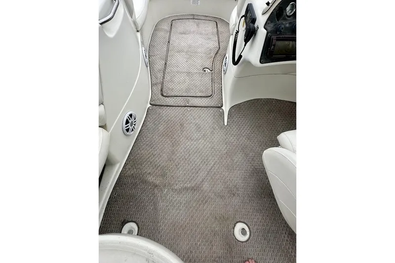 Slide: The Image of Interior of a 2004 Bennington RL 210 boat showing carpeted floor and seating area. - 26