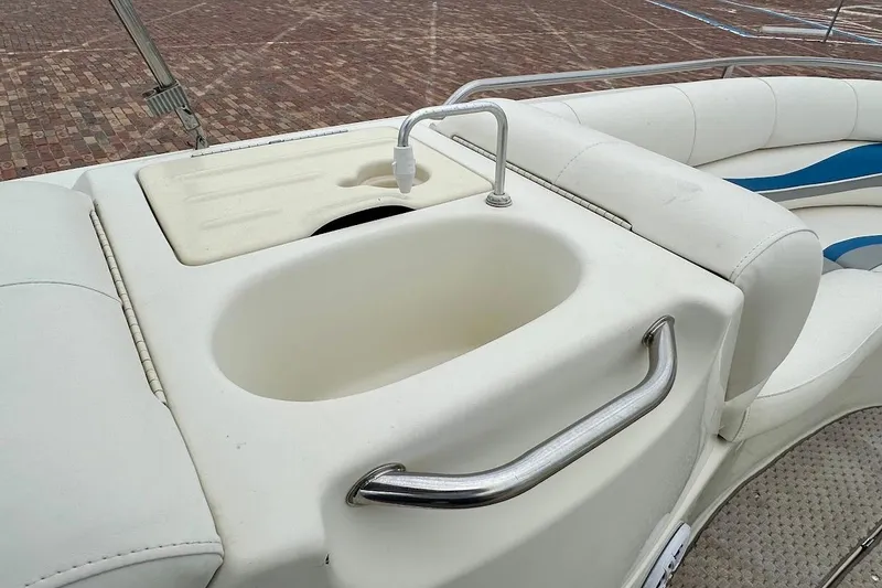 Slide: The Image of 2004 Bennington RL 210 boat interior with sink and seating area. - 27