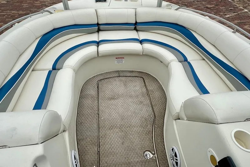 Slide: The Image of 2004 Bennington RL 210 boat interior with white and blue cushioned seating. - 28