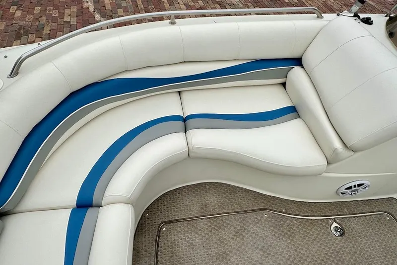 Slide: The Image of 2004 Bennington RL 210 boat interior with white and blue cushioned seating. - 29