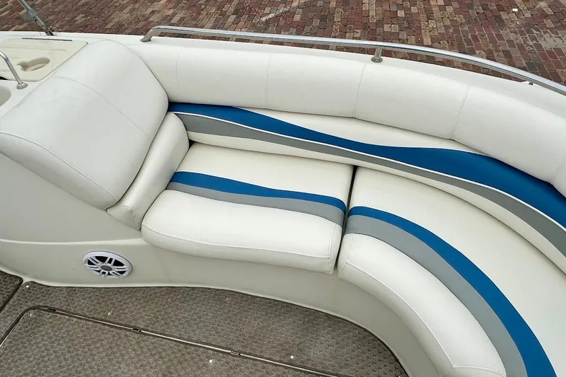 Slide: The Image of 2004 Bennington RL 210 boat interior with white and blue cushioned seating. - 30