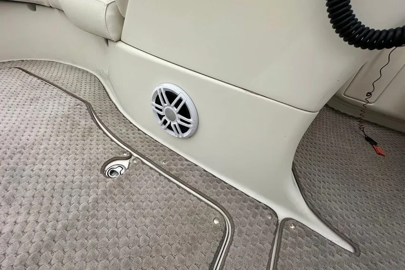 Slide: The Image of 2004 Bennington RL 210 boat interior with speaker and carpeted flooring. - 35