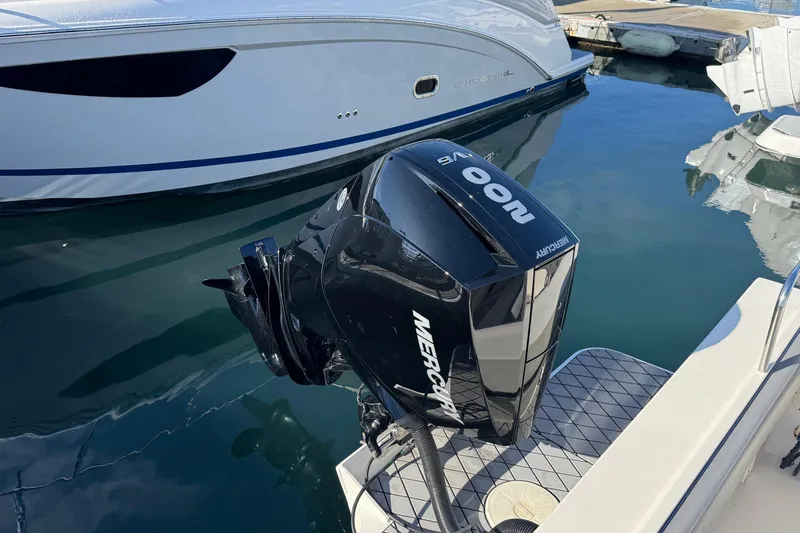 Slide: The Image of 2023 Defiance Admiral 220 EX with Mercury outboard engine at marina. - 16
