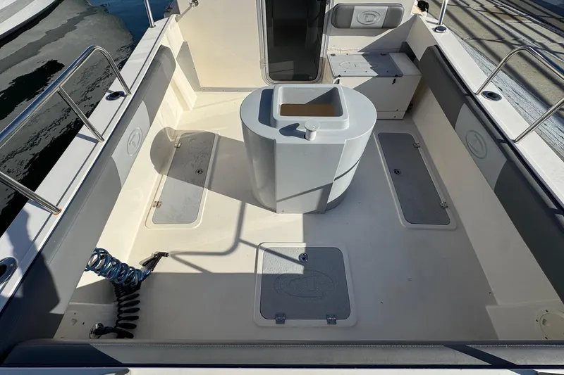 Slide: The Image of 2023 Defiance Admiral 220 EX boat deck with storage compartments and seating. - 19