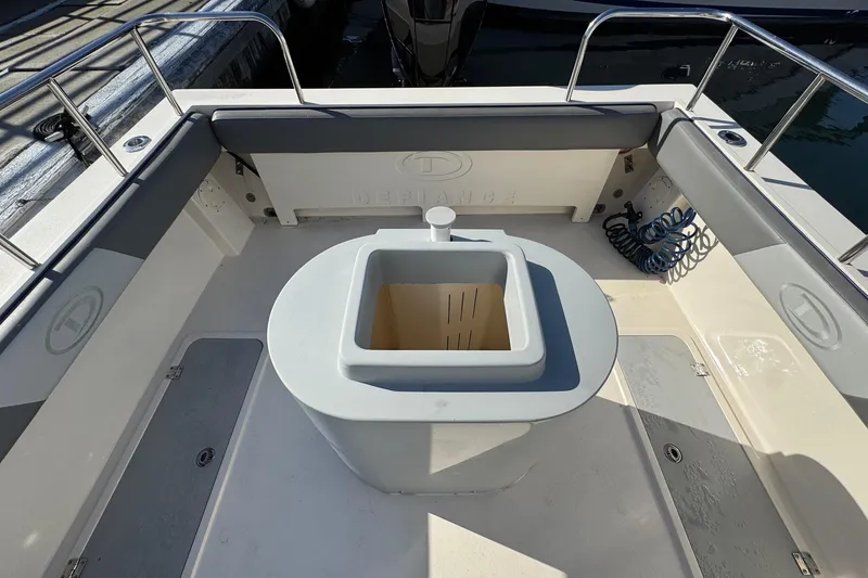 Slide: The Image of 2023 Defiance Admiral 220 EX boat interior with seating and storage. - 21