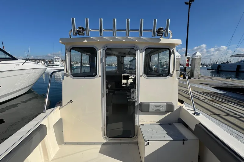 Slide: The Image of 2023 Defiance Admiral 220 EX boat docked at marina under clear blue sky. - 29