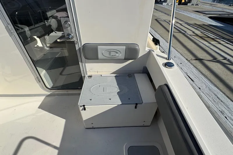 Slide: The Image of 2023 Defiance Admiral 220 EX boat interior with seating and storage compartment. - 30