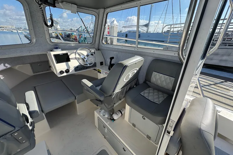 Slide: The Image of Interior of 2023 Defiance Admiral 220 EX boat with modern helm and seating. - 34