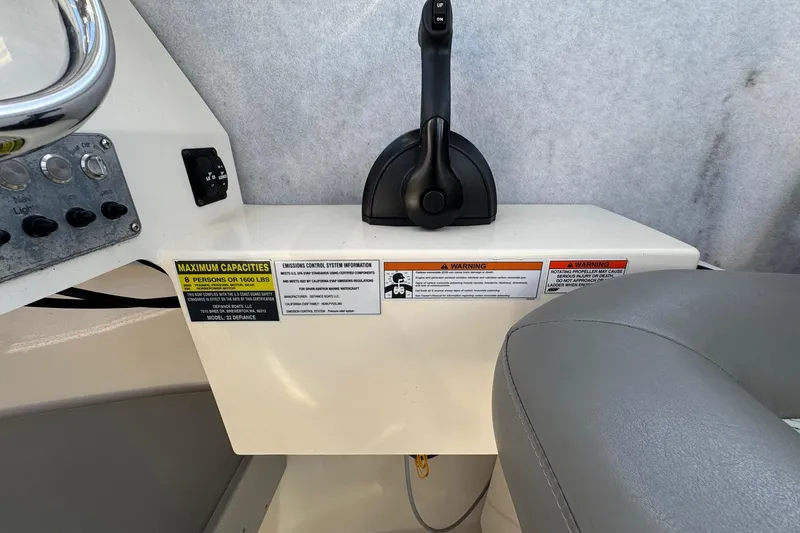 Slide: The Image of 2023 Defiance Admiral 220 EX boat controls with capacity and warning labels. - 45