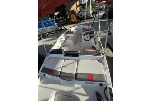 Slide: The Image of 2024 Tahoe T16 boat interior with seating and steering wheel under canopy. - 3