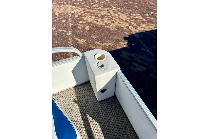 Slide: The Image of 2004 Crest 2200 Family DL boat interior with cup holder and carpeted floor. - 13