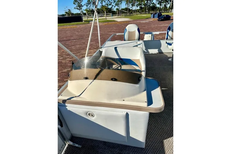 Slide: The Image of 2004 Crest 2200 Family DL boat interior with steering console and seating. - 21