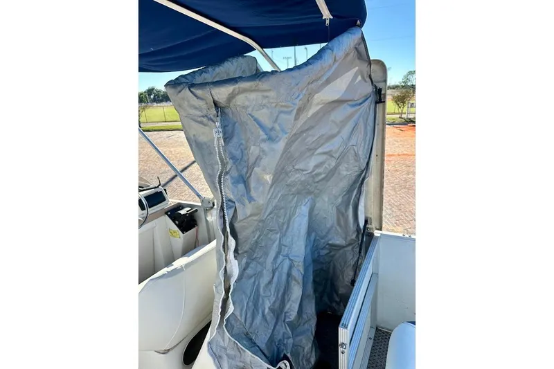 Slide: The Image of 2004 Crest 2200 Family DL boat with blue canopy and gray cover. - 26