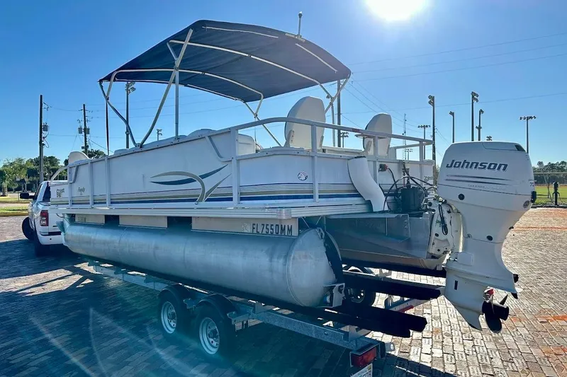 Slide: The Image of 2004 Crest 2200 Family DL pontoon boat with Johnson outboard motor on trailer. - 4