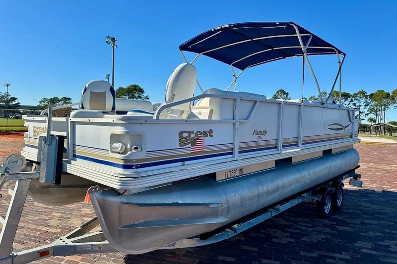 Slide: The Image of 2004 Crest 2200 Family DL pontoon boat on trailer, featuring canopy and seating. - 5