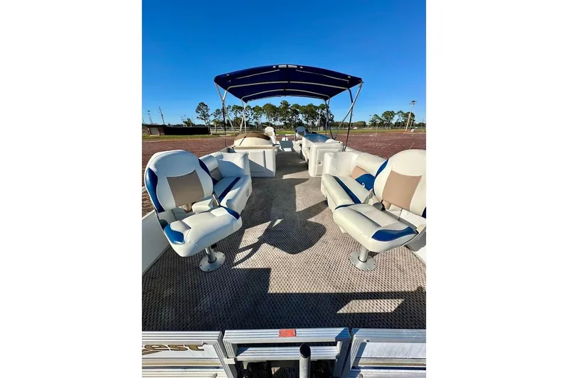 Slide: The Image of 2004 Crest 2200 Family DL pontoon boat with seating and canopy under clear blue sky. - 7