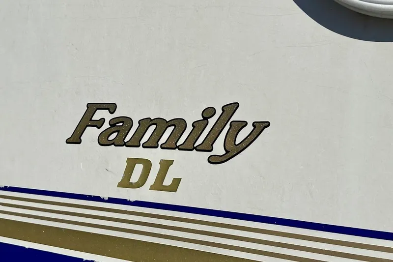 Slide: The Image of Crest 2200 Family DL 2004 boat logo with blue and gold stripes. - 8