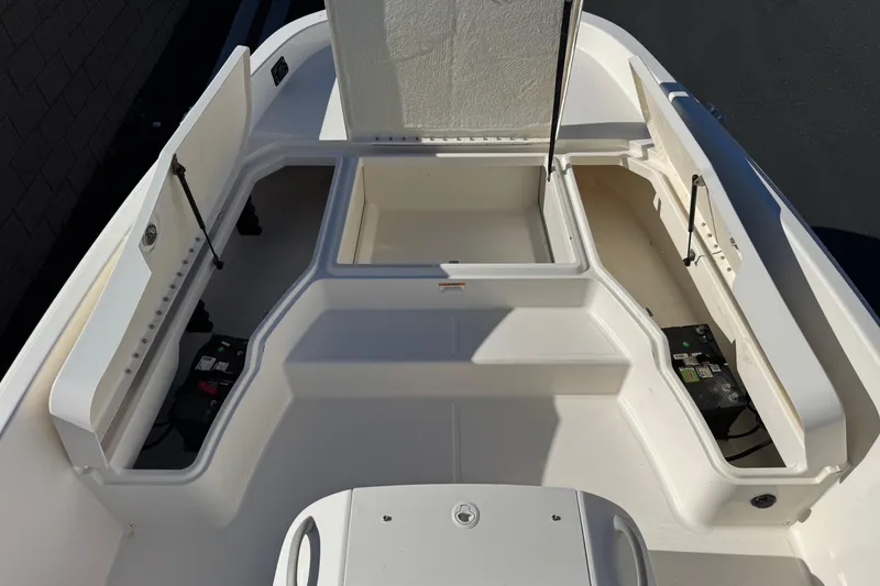 Slide: The Image of 2021 Trophy T21 Bay boat interior with open storage compartments and batteries. - 10