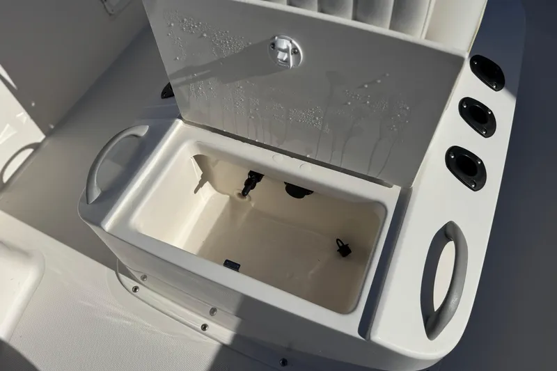 Slide: The Image of 2021 Trophy T21 Bay boat storage compartment with rod holders and handles. - 14