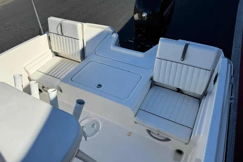 Slide: The Image of 2021 Trophy T21 Bay boat interior with white seating and rod holders. - 16