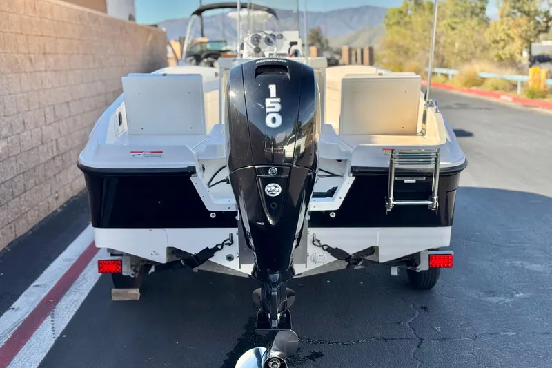 Slide: The Image of 2021 Trophy T21 Bay boat with 150 HP outboard motor, parked on pavement. - 4