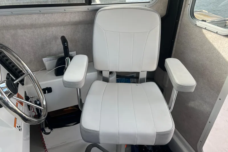 Slide: The Image of Captain's chair in 2022 Parker 2320 Sport Cabin boat interior. - 10