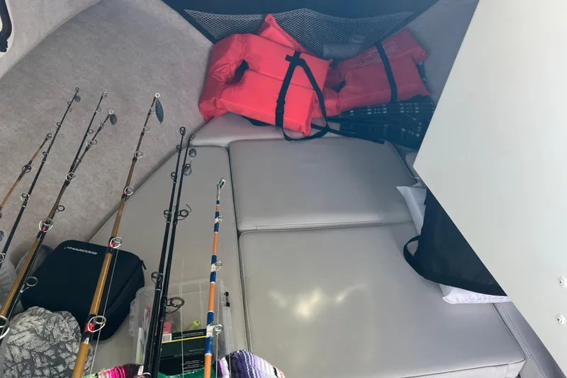 Slide: The Image of Interior of 2022 Parker 2320 Sport Cabin with fishing rods and life jackets. - 12