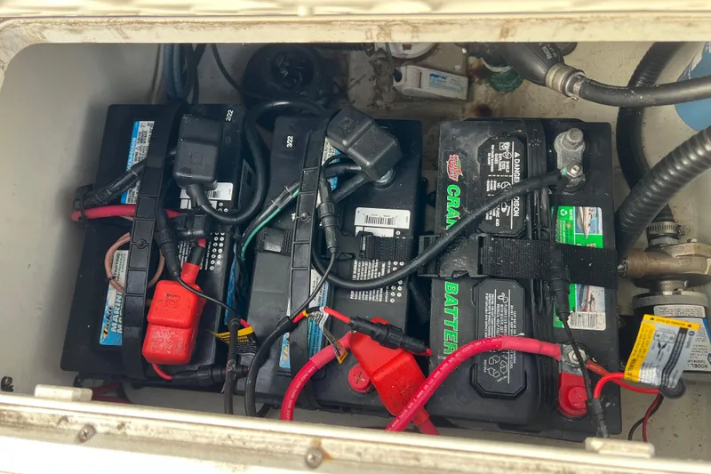 Slide: The Image of Battery compartment of a 2022 Parker 2320 Sport Cabin boat, showing multiple marine batteries. - 19