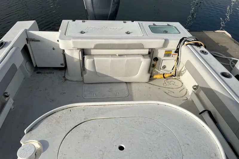 Slide: The Image of 2022 Parker 2320 Sport Cabin boat interior with storage and seating area. - 21