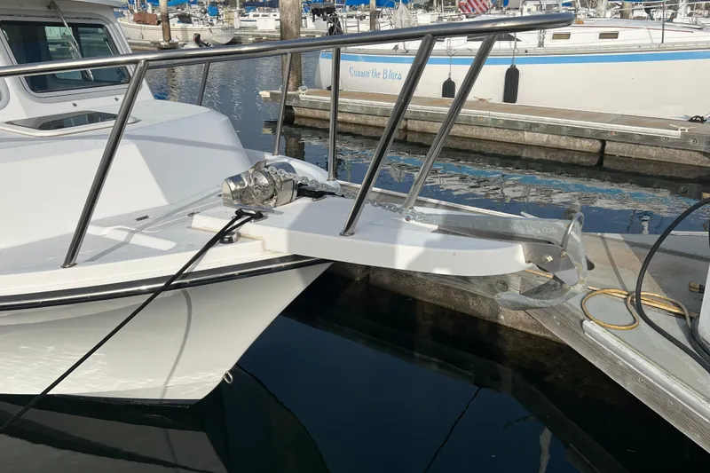 Slide: The Image of 2022 Parker 2320 Sport Cabin boat docked with anchor system visible. - 22