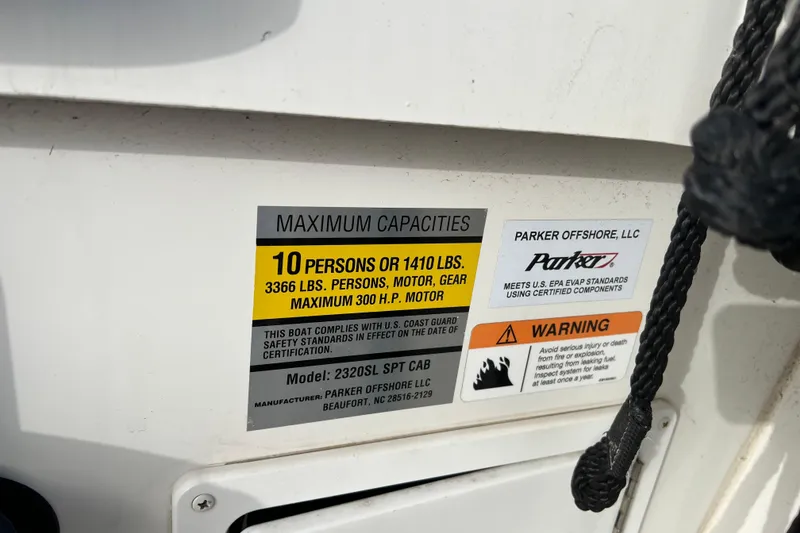 Slide: The Image of Parker 2320 Sport Cabin 2022 capacity label, 10 persons or 1410 lbs, safety warnings. - 25