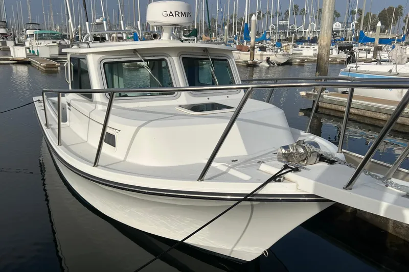 Slide: The Image of 2022 Parker 2320 Sport Cabin boat docked in marina with Garmin equipment. - 26