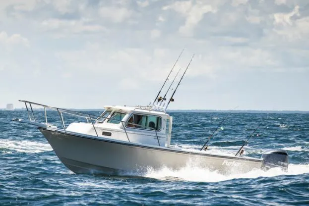 Slide: The Image of Manufacturer Provided Image: 2022 Parker 2320 Sport Cabin boat cruising on the ocean with fishing rods. - 29