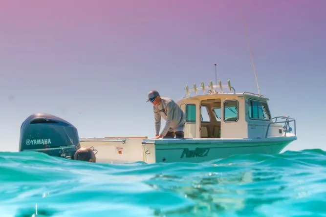 Slide: The Image of Manufacturer Provided Image: 2022 Parker 2320 Sport Cabin boat on clear blue water with a Yamaha engine. - 30
