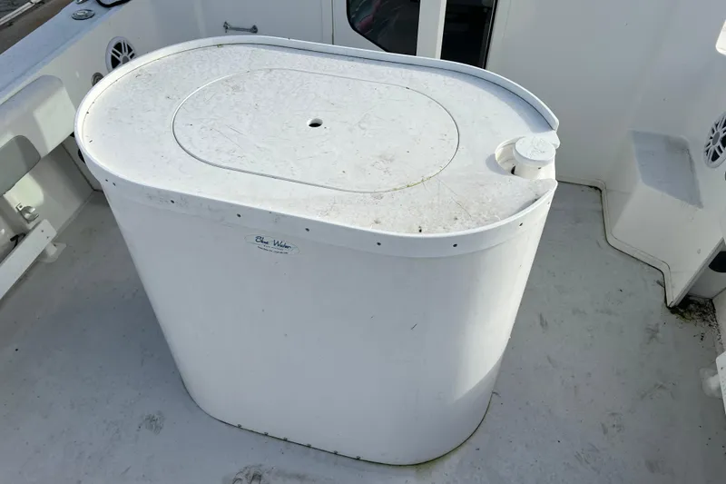 Slide: The Image of 2022 Parker 2320 Sport Cabin boat deck with white storage compartment. - 7