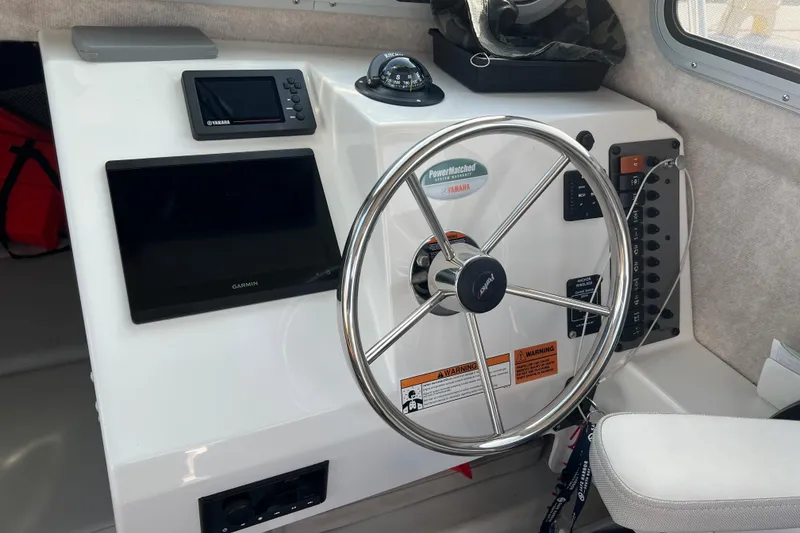 Slide: The Image of 2022 Parker 2320 Sport Cabin helm with Garmin electronics and Yamaha controls. - 8