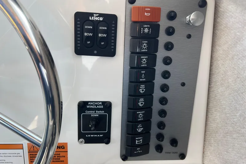 Slide: The Image of Control panel of 2022 Parker 2320 Sport Cabin boat with switches and steering wheel. - 9