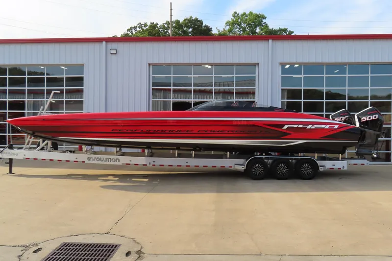 The Image of 2025 Performance Powerboats P420 in red on a trailer outside a building. - 1