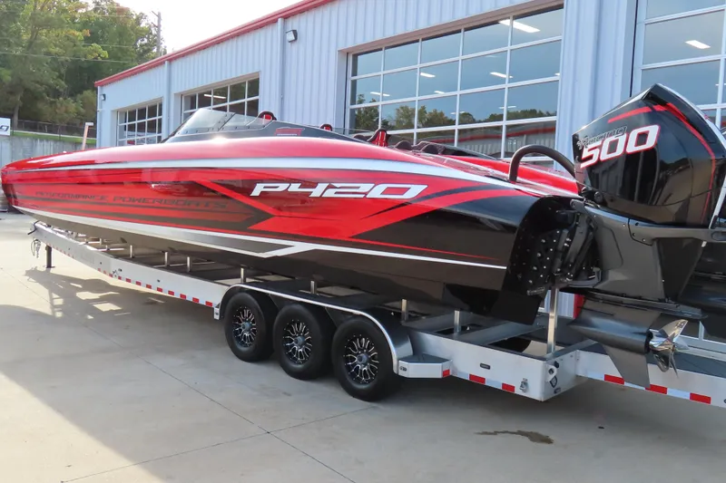 Slide: The Image of 2025 Performance Powerboats P420 on trailer, sleek red and black design, outside showroom. - 5