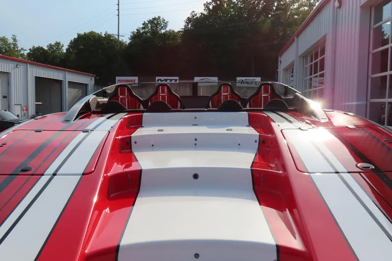 Slide: The Image of 2025 Performance Powerboats P420 with red and white design, parked outdoors. - 6