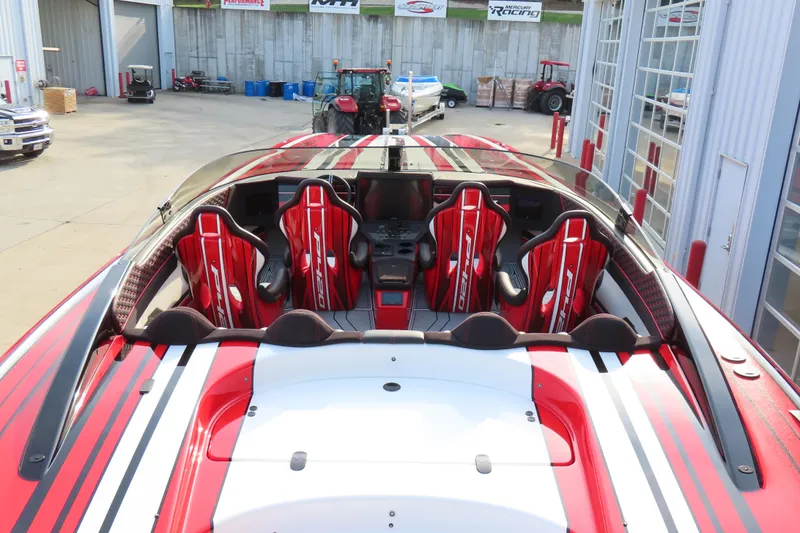 Slide: The Image of 2025 Performance Powerboats P420 with red and white striped seats in a showroom. - 7