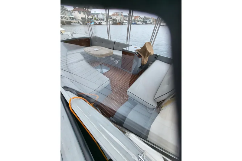 Slide: The Image of 2018 Duffy Sun Chaser boat interior with seating, table, and waterfront view. - 2