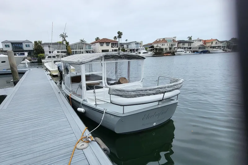 Slide: The Image of 2018 Duffy Sun Chaser boat docked in a marina with waterfront homes. - 3