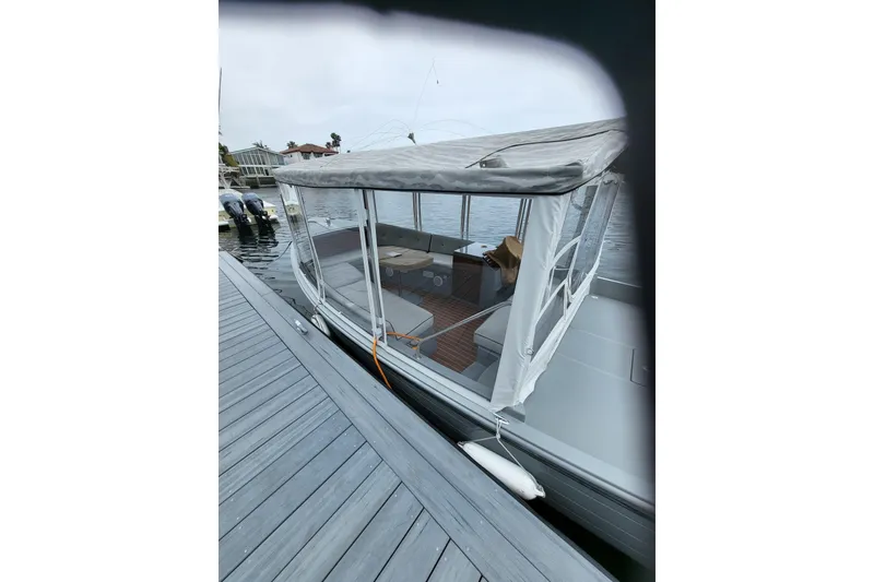 Slide: The Image of 2018 Duffy Sun Chaser boat docked, featuring canopy and seating area. - 4