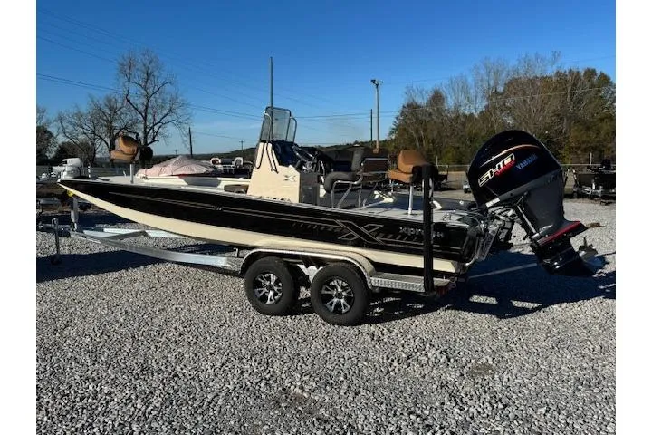 Slide: The Image of 2026 Xpress H22B Bay boat on trailer with Yamaha outboard motor, parked on gravel. - 10