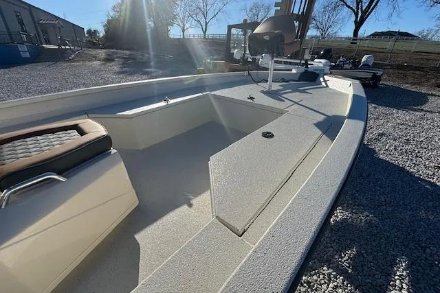 Slide: The Image of 2026 Xpress H22B Bay boat with spacious deck and seating, parked outdoors. - 6