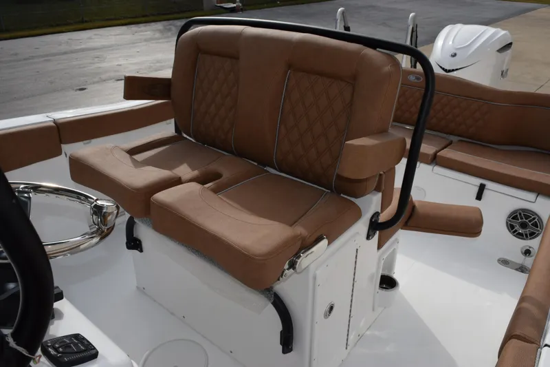 Slide: The Image of 2026 Sea Hunt Ultra 255 SE boat interior with brown cushioned seating. - 12
