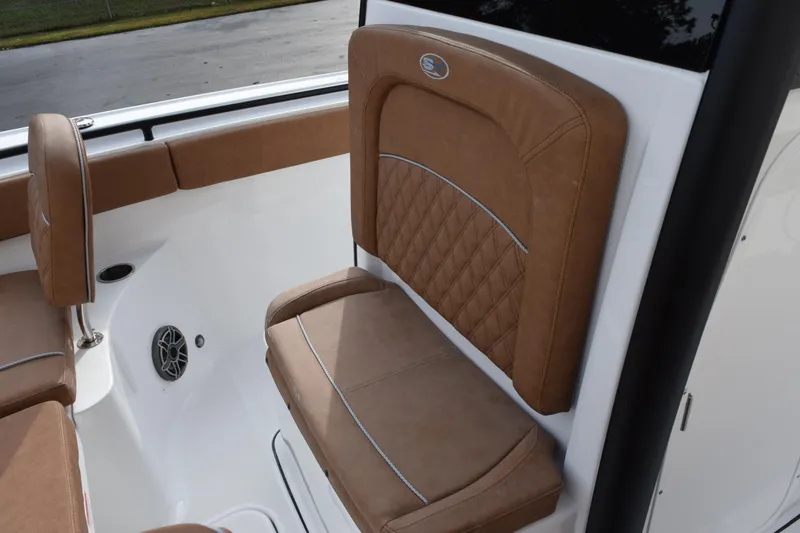 Slide: The Image of 2026 Sea Hunt Ultra 255 SE boat interior with brown cushioned seating. - 14