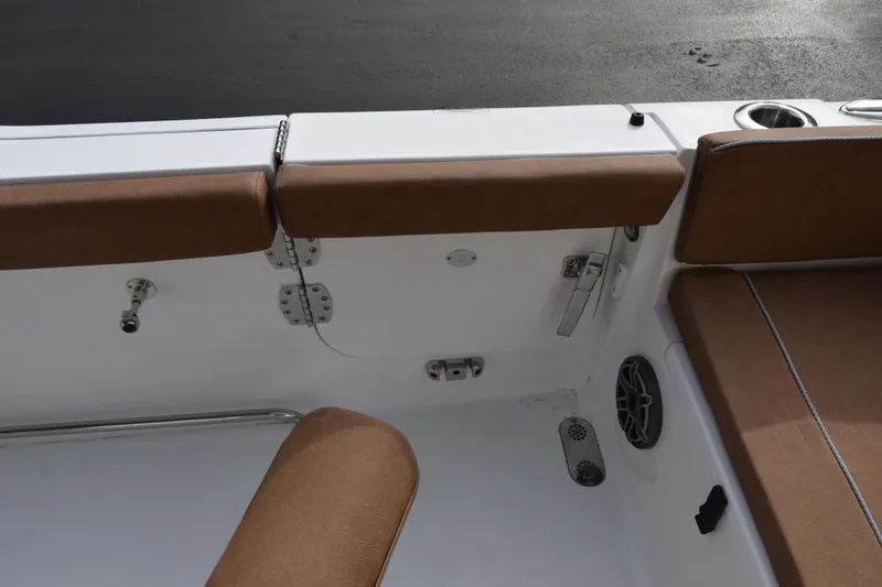 Slide: The Image of 2026 Sea Hunt Ultra 255 SE boat interior with brown seating and cup holder. - 22