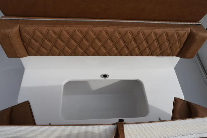 Slide: The Image of 2026 Sea Hunt Ultra 255 SE boat interior with brown diamond-stitched seating and storage compartment. - 23